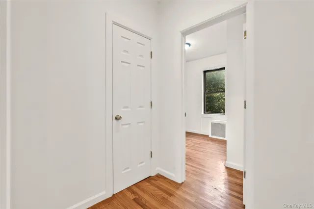 a view of a hallway with wooden floor