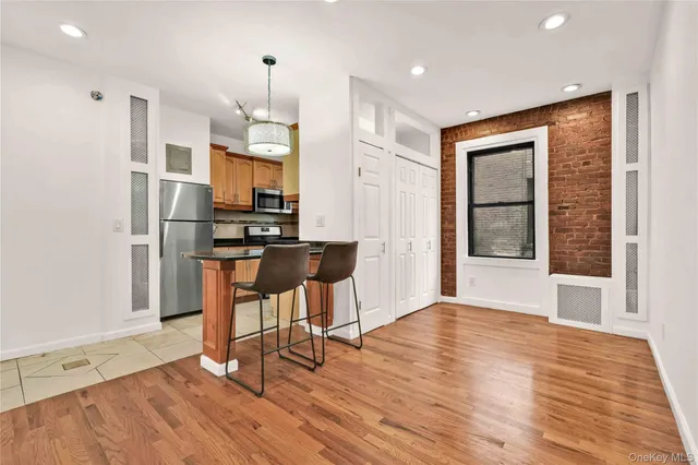 a view of kitchen with refrigerator and microwave