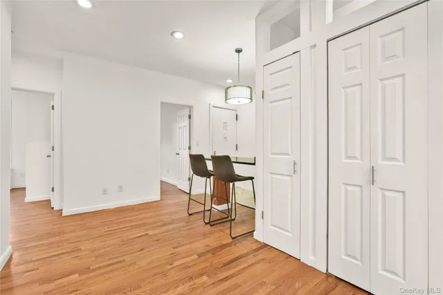 a view of a room with wooden floor table and chairs
