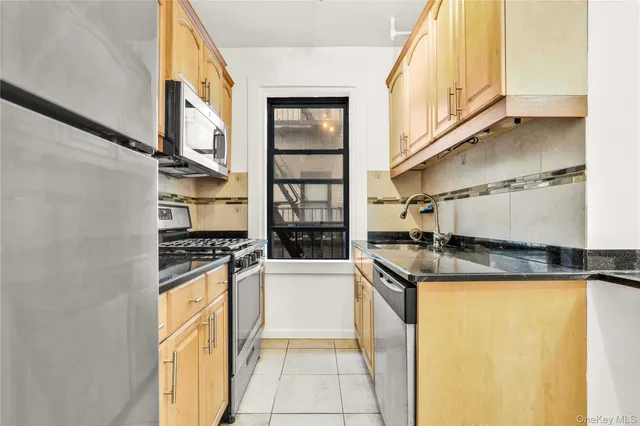 a kitchen with granite countertop a stove and a sink
