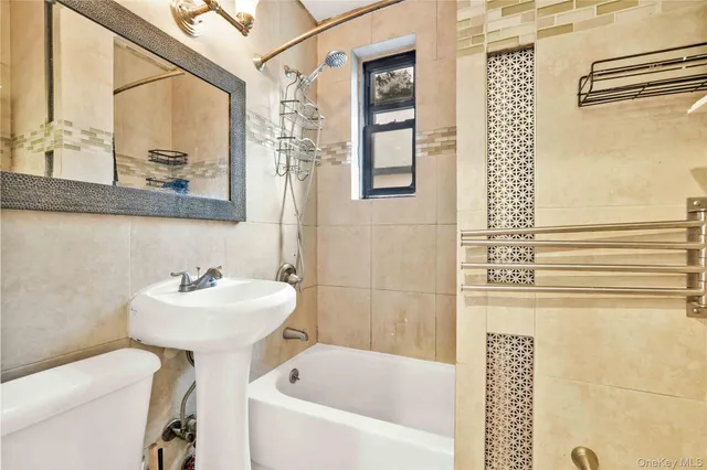 a bathroom with a sink mirror and a bathtub