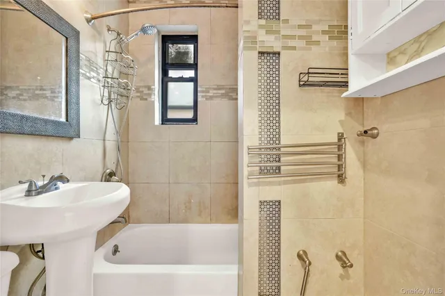 a bathroom with a sink a mirror and shower