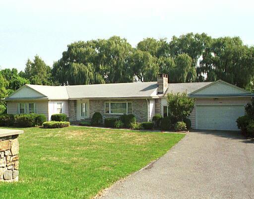 67 Clapboard Ridge Road Danbury, CT 06811 - Photo 1 of 1 a front view of a house with a yard and garage