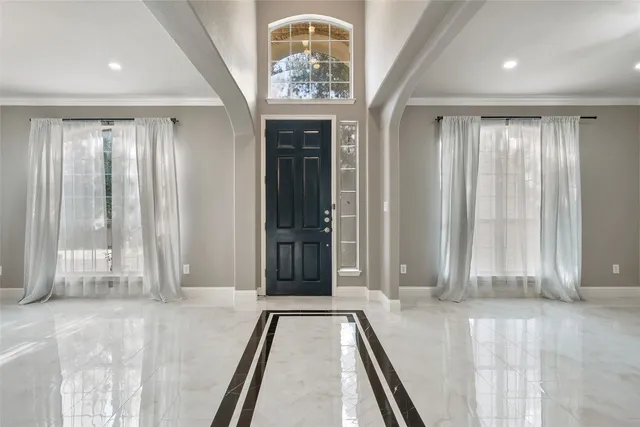 a front view of a house with a yard and tree s