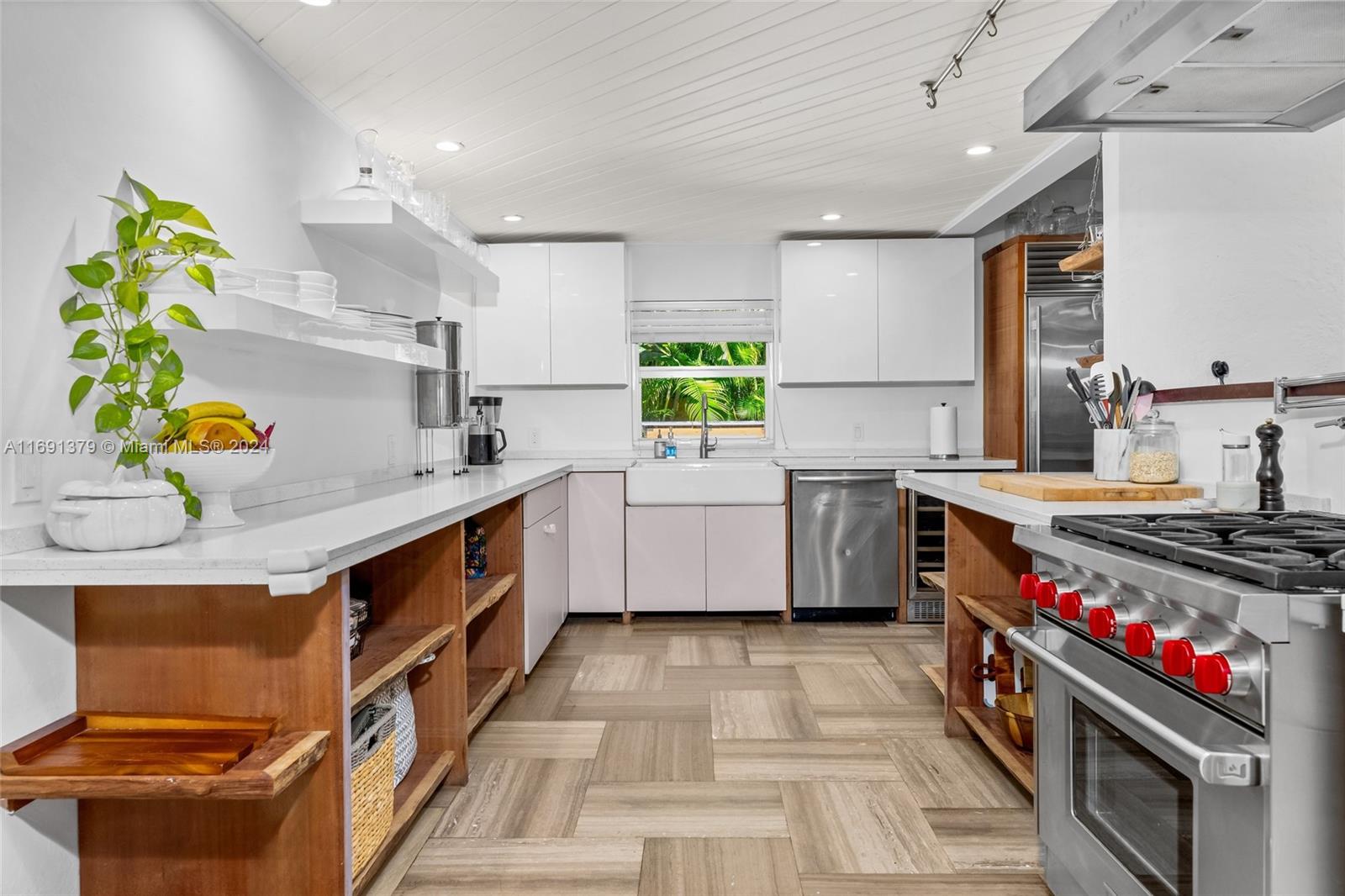 3685 St Gaudens Road Miami, FL 33133 - Photo 14 of 66 a kitchen with stainless steel appliances a sink and a stove