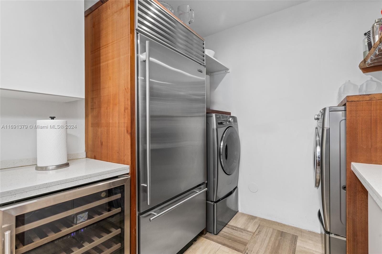3685 St Gaudens Road Miami, FL 33133 - Photo 19 of 66 a kitchen with a refrigerator and cabinets