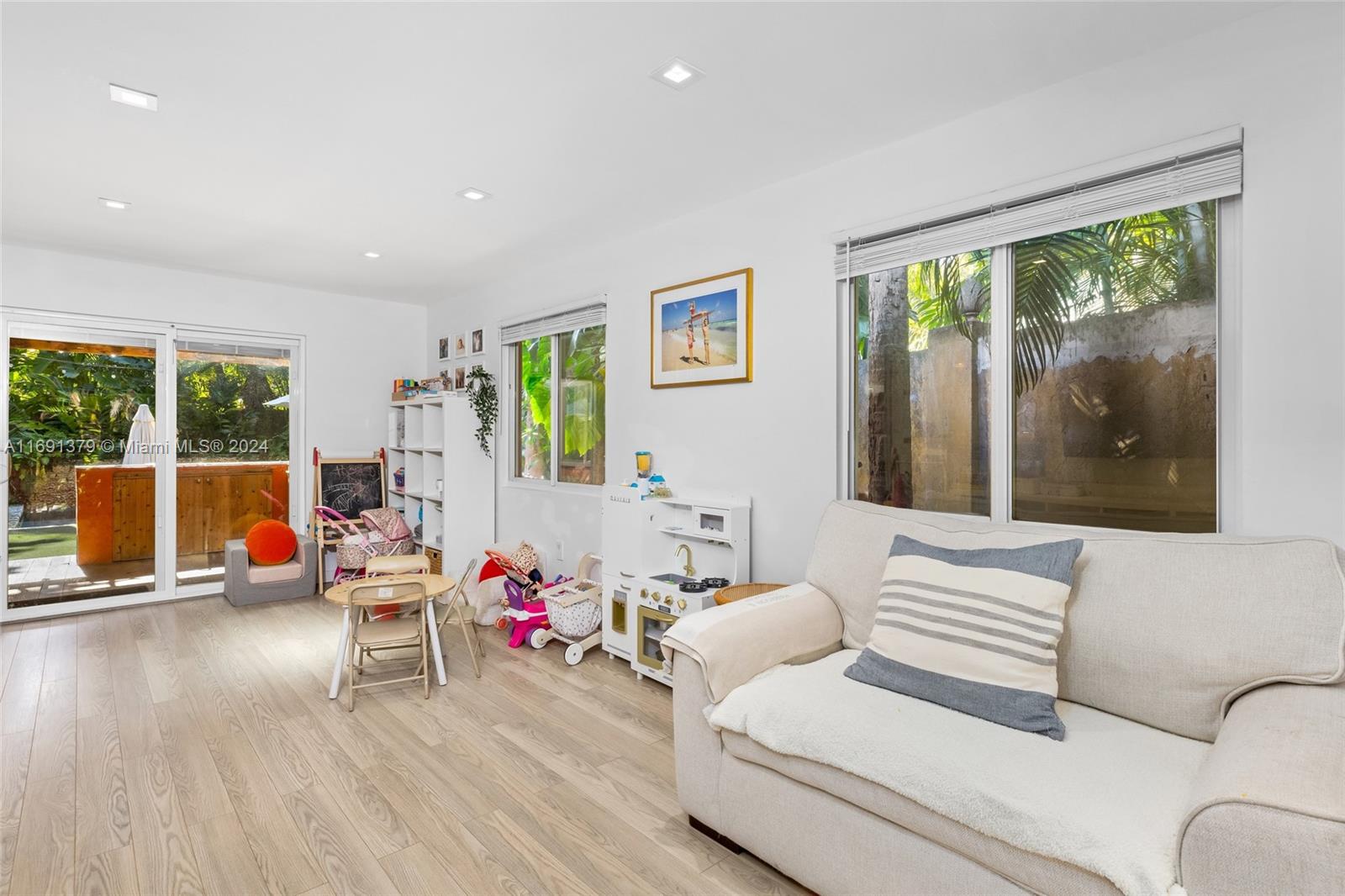 3685 St Gaudens Road Miami, FL 33133 - Photo 24 of 66 a living room with furniture and a large window