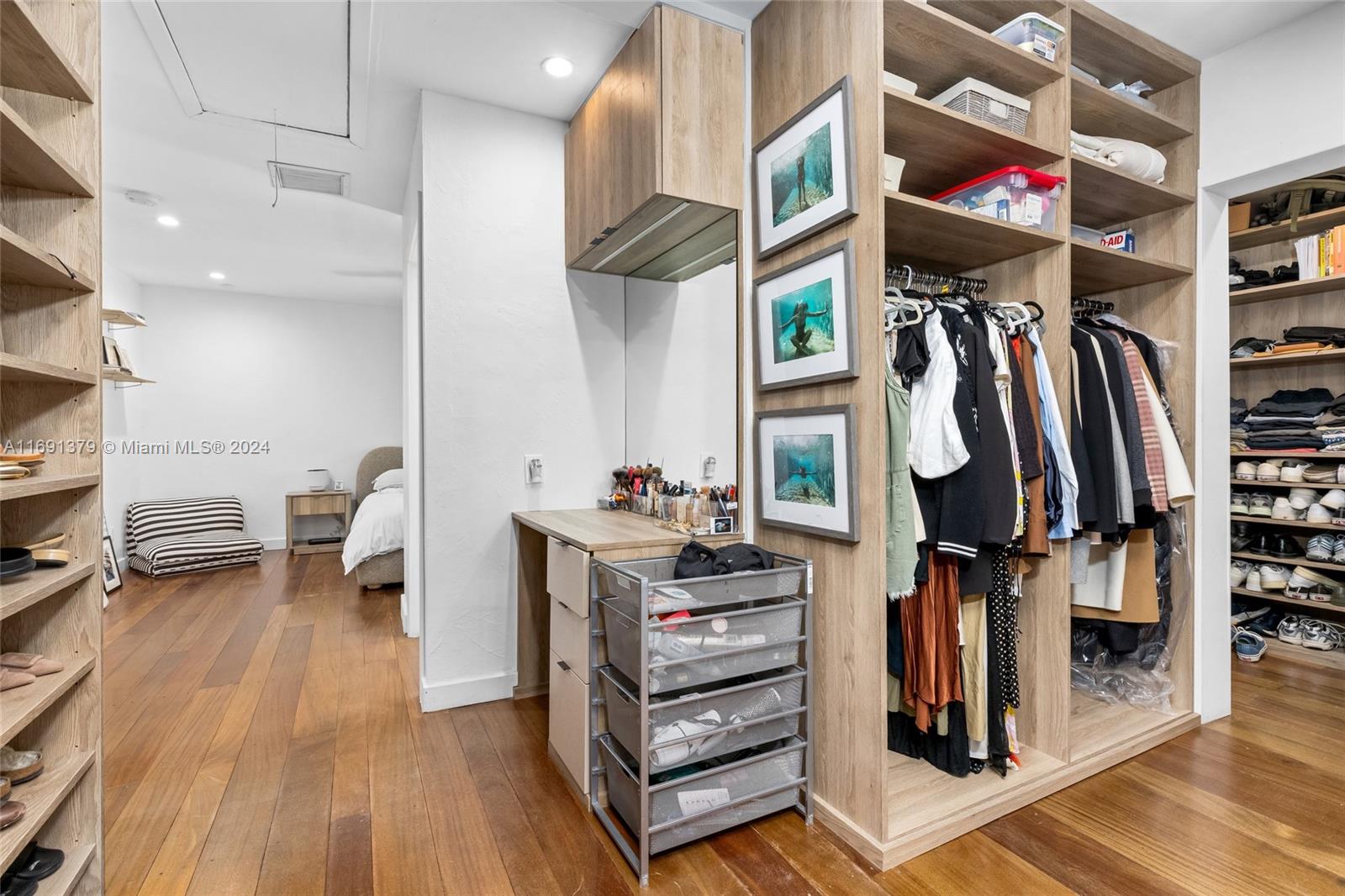 3685 St Gaudens Road Miami, FL 33133 - Photo 26 of 66 a view of walk in closet with clothes and shoes