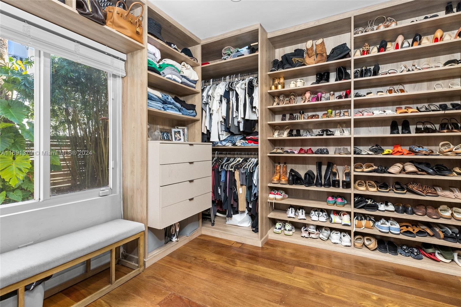 3685 St Gaudens Road Miami, FL 33133 - Photo 28 of 66 a view of walk in closet with clothes and shoes