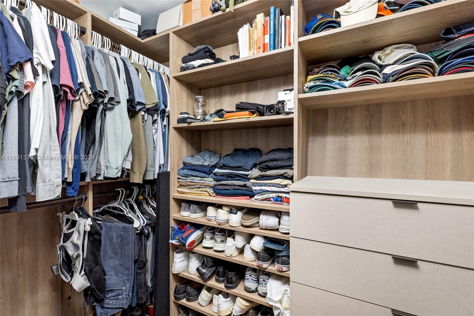 3685 St Gaudens Road Miami, FL 33133 - Photo 29 of 66 a view of walk in closet with clothes and shoes