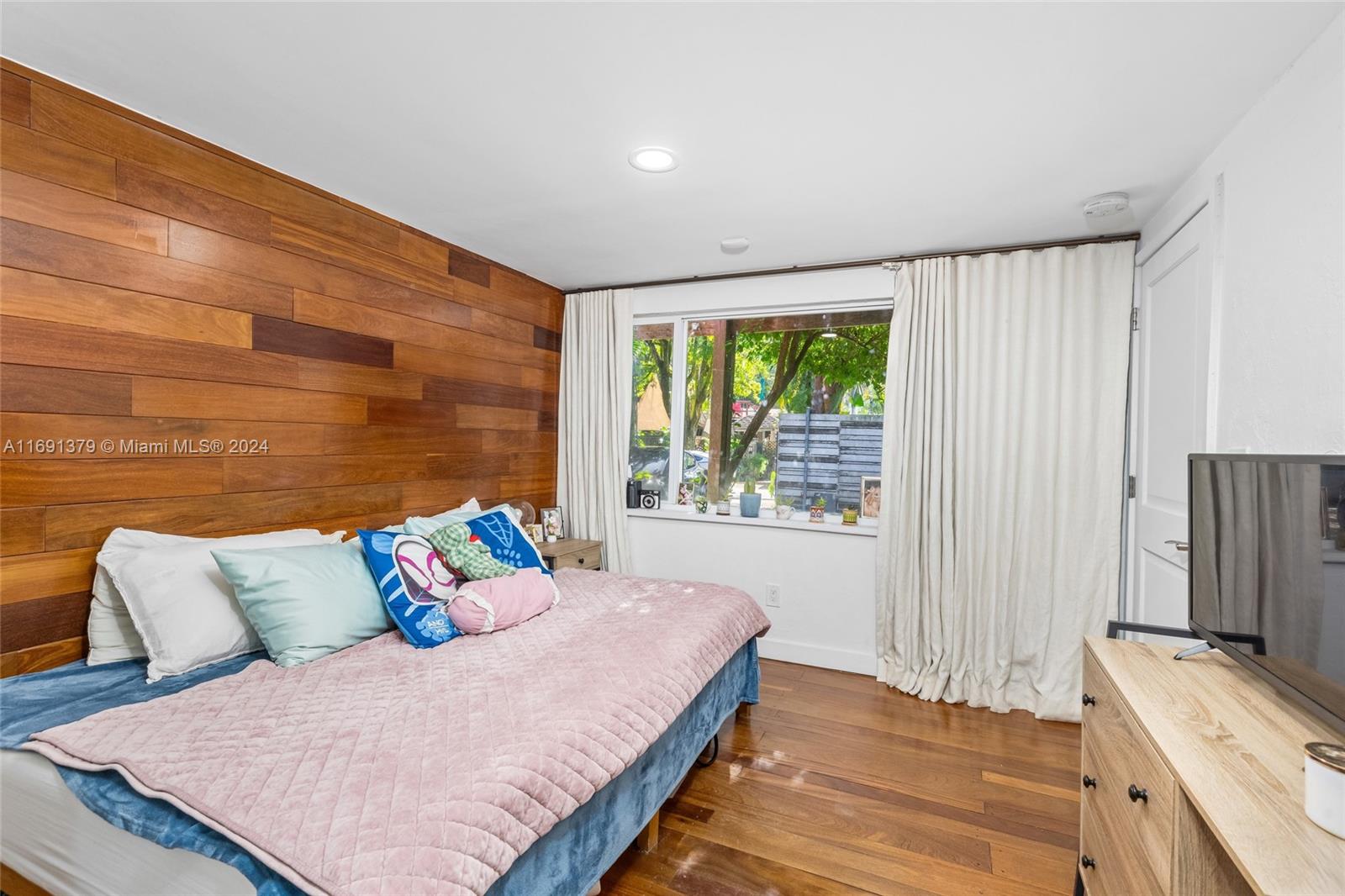 3685 St Gaudens Road Miami, FL 33133 - Photo 33 of 66 a bedroom with a bed and wooden floor