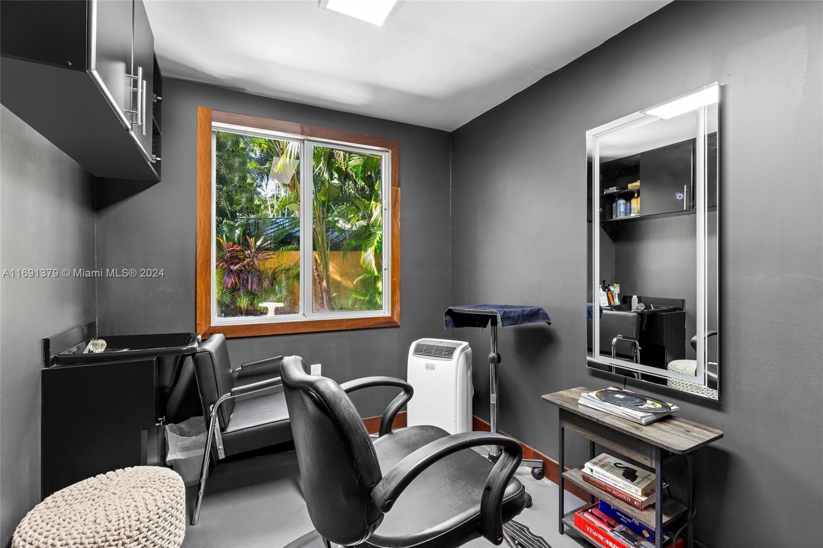 3685 St Gaudens Road Miami, FL 33133 - Photo 41 of 66 a view of a workspace with furniture and a window