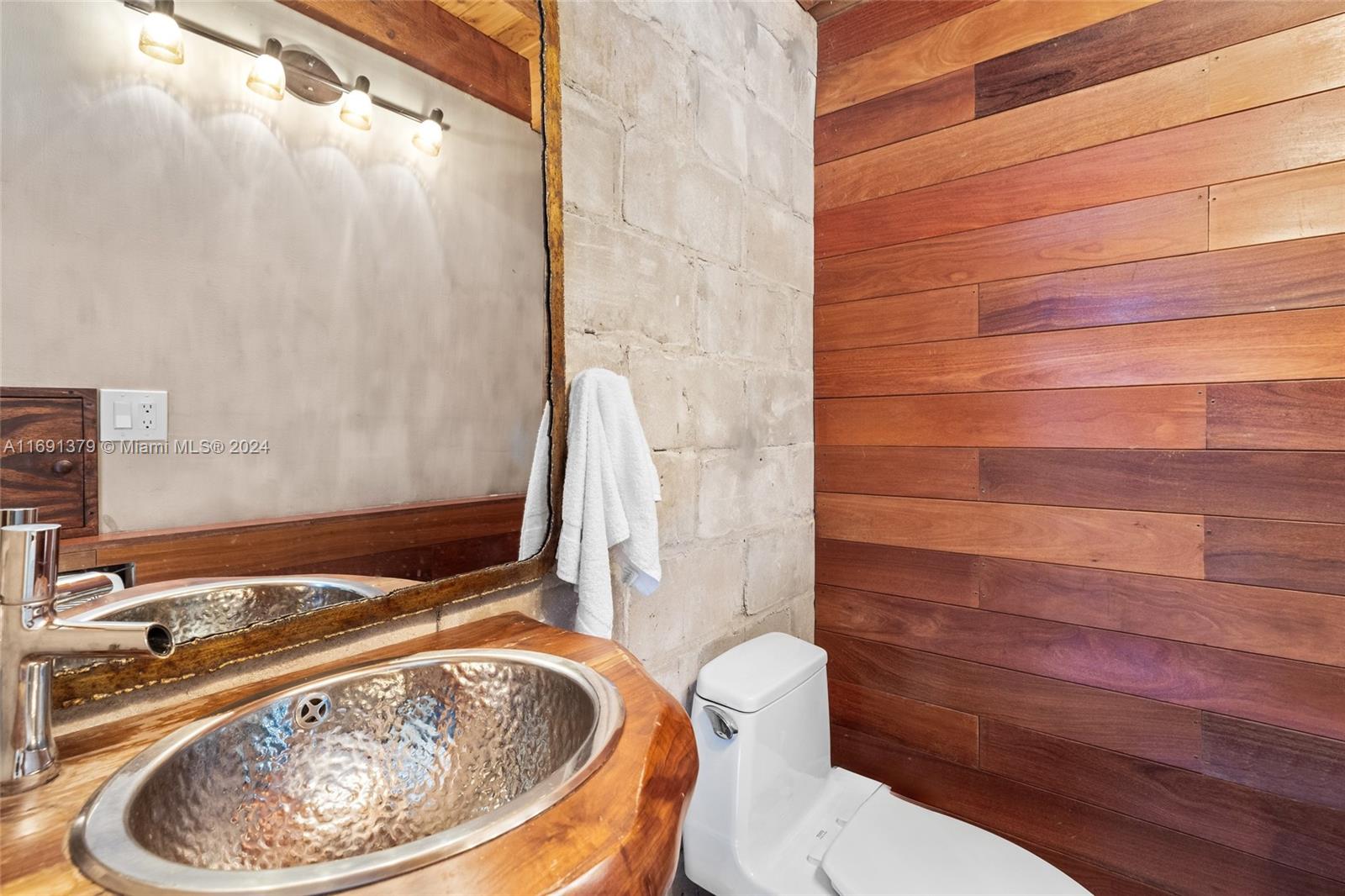 3685 St Gaudens Road Miami, FL 33133 - Photo 42 of 66 a bathroom with a sink and a toilet