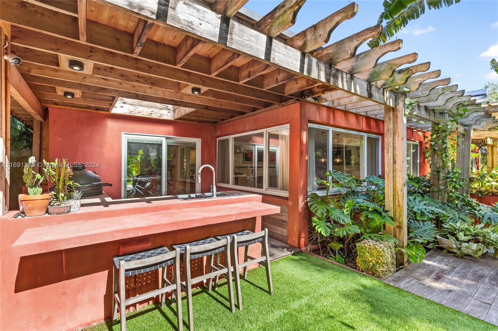3685 St Gaudens Road Miami, FL 33133 - Photo 45 of 66 a patio with table and chairs and potted plants