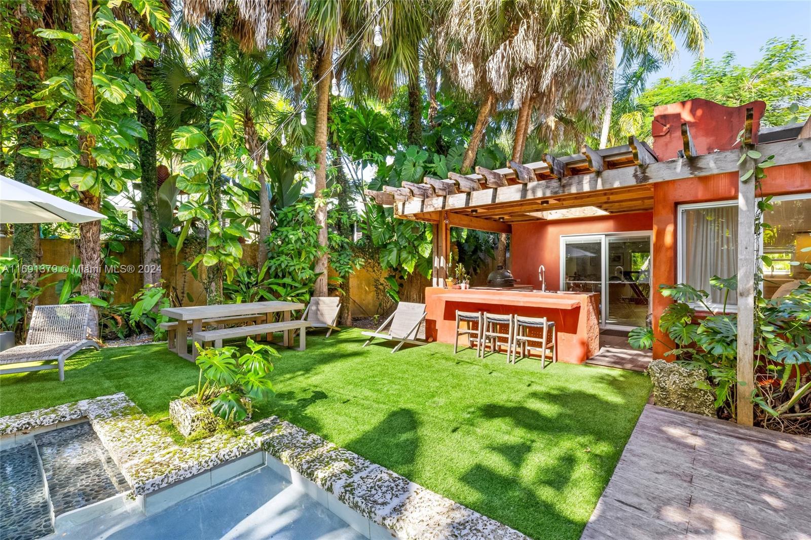 3685 St Gaudens Road Miami, FL 33133 - Photo 49 of 66 a view of a house with a yard and sitting area