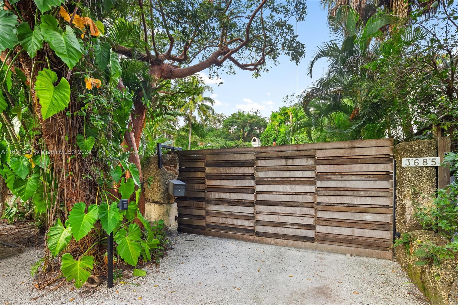 3685 St Gaudens Road Miami, FL 33133 - Photo 60 of 66 a view of a wooden fence and trees
