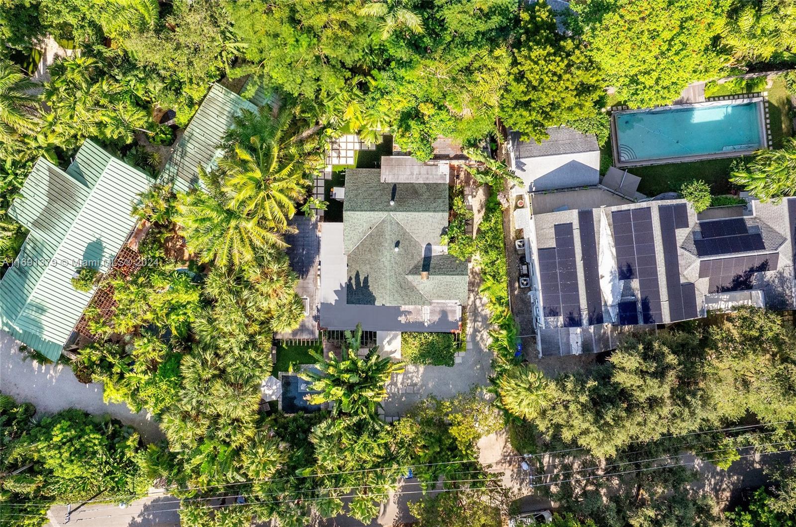 3685 St Gaudens Road Miami, FL 33133 - Photo 63 of 66 an aerial view of a house with a yard and garden in front of it