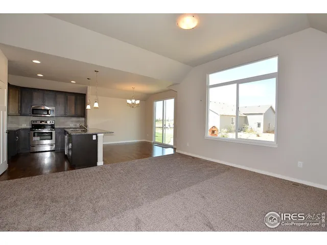 a view of kitchen with stainless steel appliances kitchen island granite countertop a stove top oven a sink with wooden cabinets