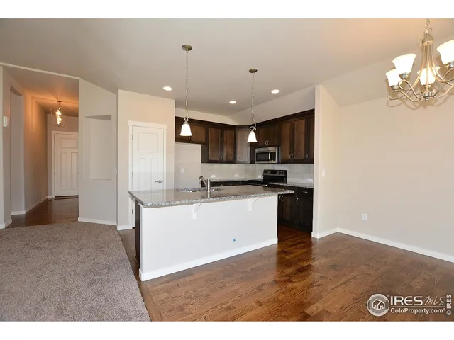 a kitchen with kitchen island a sink stainless steel appliances and cabinets