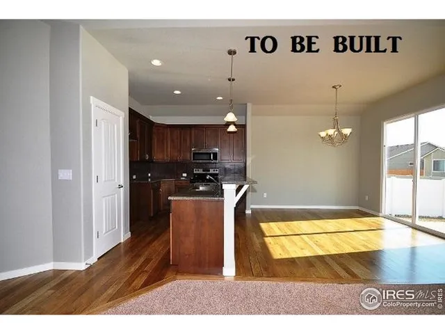 a kitchen with stainless steel appliances granite countertop a sink refrigerator and cabinets