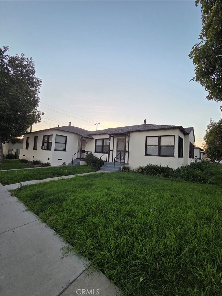 5700 Jillson Street Commerce, CA 90040 - Photo 2 of 9 a view of a yard in front of a house with large windows