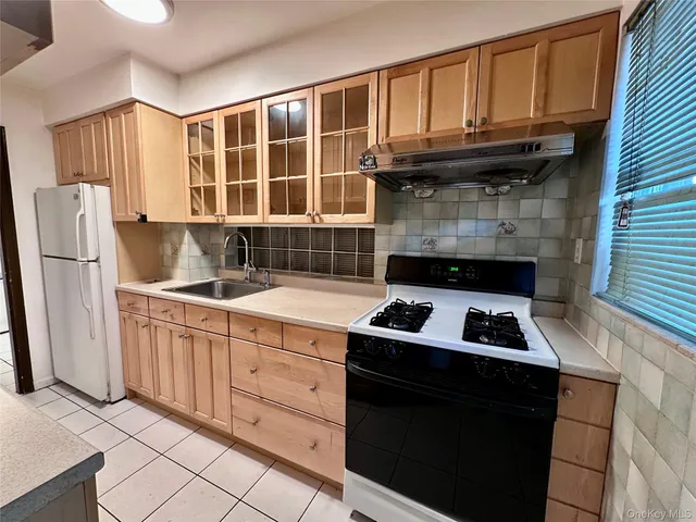 a kitchen with granite countertop cabinets and refrigerator