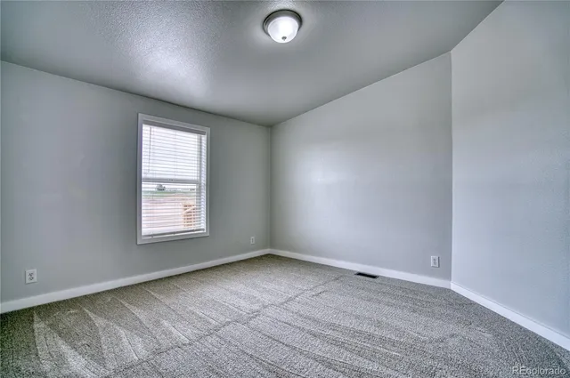 an empty room with a empty space and windows