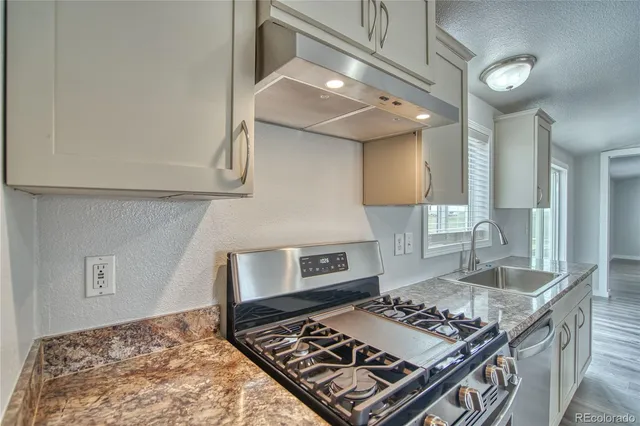 a kitchen with a stove and a sink