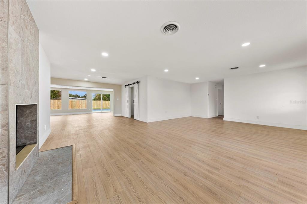 1822 Banyan Tree Drive Edgewater, FL 32132 - Photo 11 of 63 a view of empty room with wooden floor and fireplace