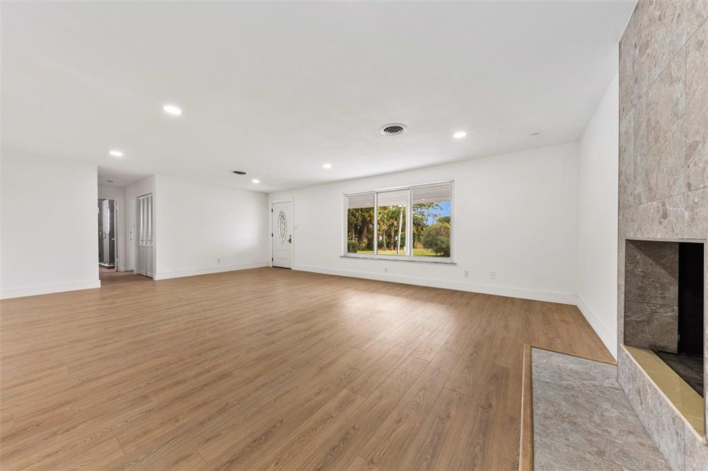 1822 Banyan Tree Drive Edgewater, FL 32132 - Photo 13 of 63 an empty room with wooden floor and windows