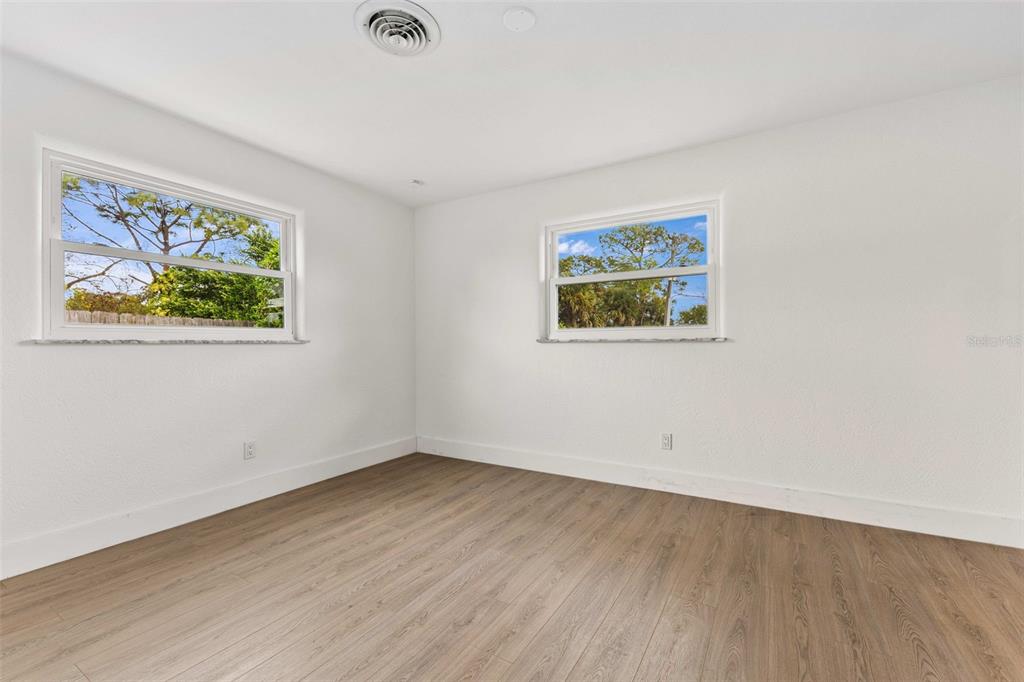 1822 Banyan Tree Drive Edgewater, FL 32132 - Photo 15 of 63 an empty room with a painting on the wall and a window