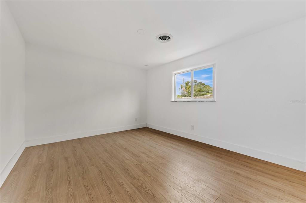 1822 Banyan Tree Drive Edgewater, FL 32132 - Photo 21 of 63 an empty room with wooden floor and windows