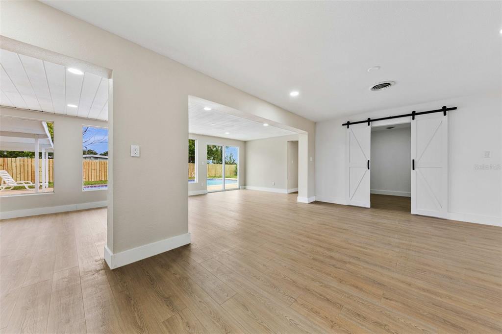 1822 Banyan Tree Drive Edgewater, FL 32132 - Photo 27 of 63 a view of an empty room with wooden floor and a window