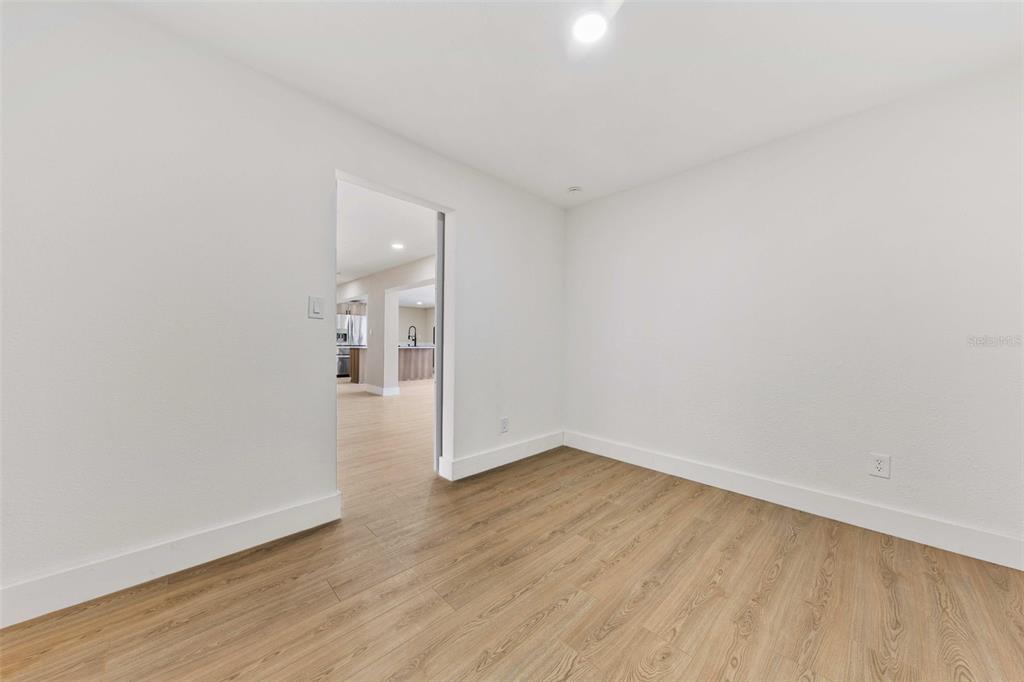 1822 Banyan Tree Drive Edgewater, FL 32132 - Photo 35 of 63 a view of an empty room with wooden floor and a window