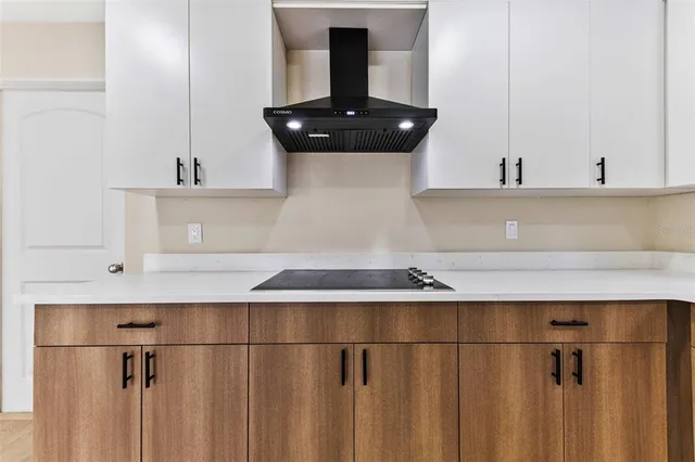 a living room with furniture kitchen view and a table