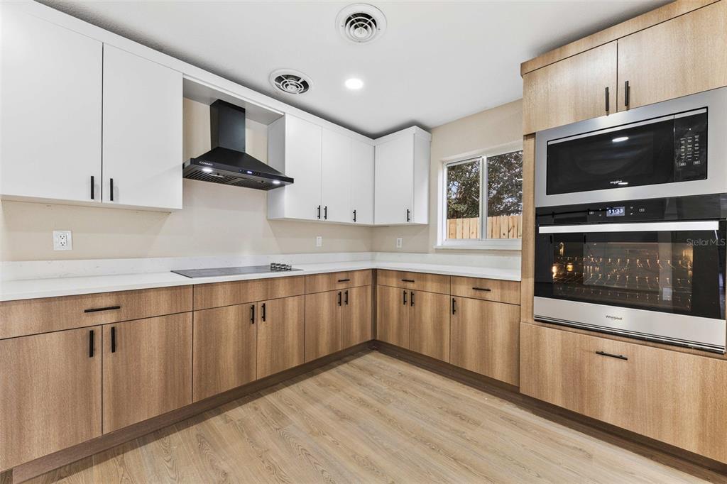 1822 Banyan Tree Drive Edgewater, FL 32132 - Photo 40 of 63 a kitchen with stainless steel appliances a stove microwave and sink