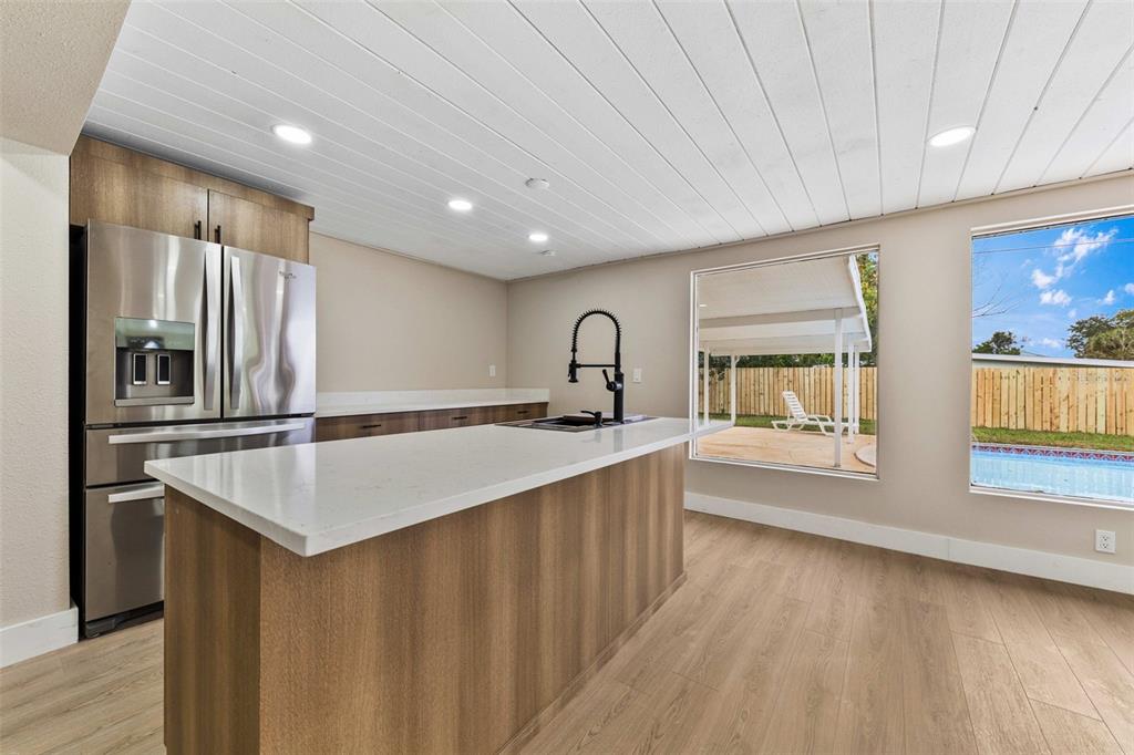 1822 Banyan Tree Drive Edgewater, FL 32132 - Photo 41 of 63 a kitchen with stainless steel appliances granite countertop a sink a stove and a refrigerator
