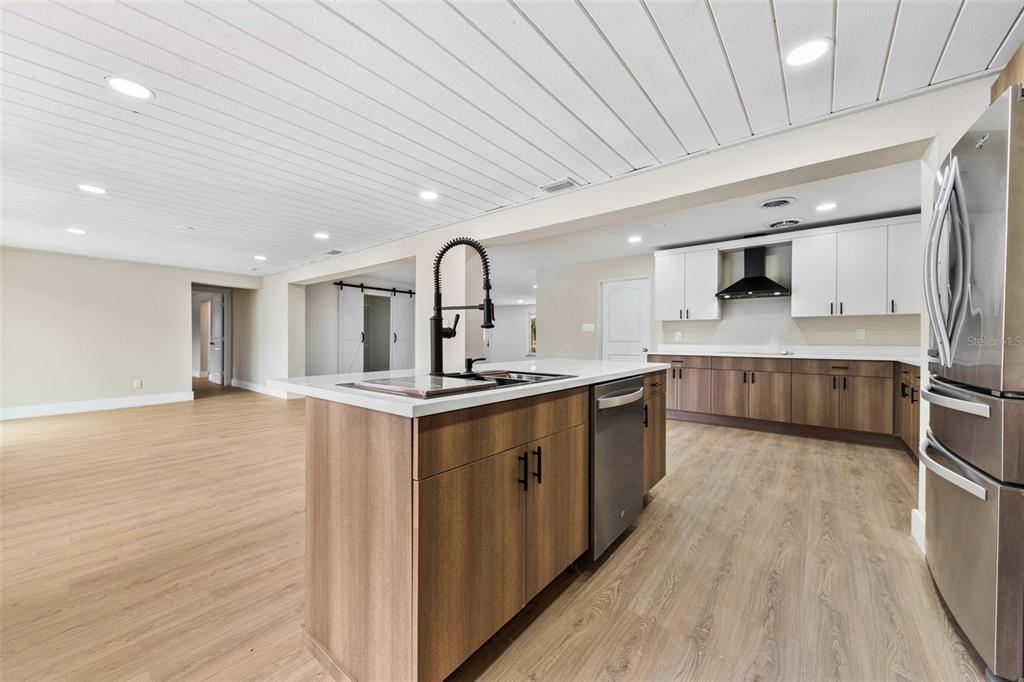 1822 Banyan Tree Drive Edgewater, FL 32132 - Photo 43 of 63 a large kitchen with stainless steel appliances granite countertop a lot of counter space and wooden floors