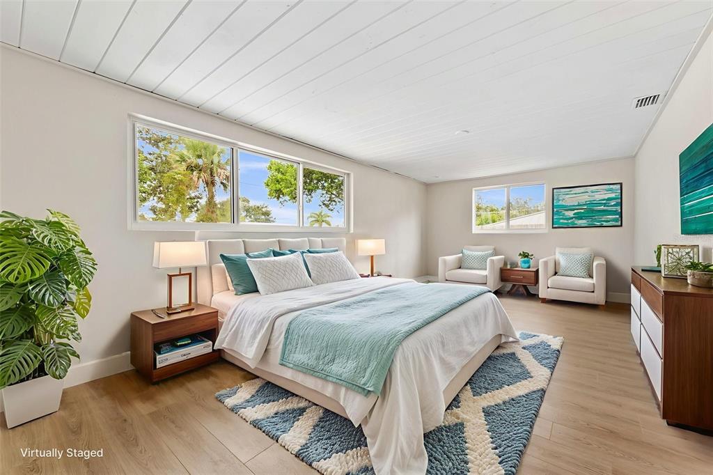 1822 Banyan Tree Drive Edgewater, FL 32132 - Photo 51 of 63 a spacious bedroom with a bed and a couch