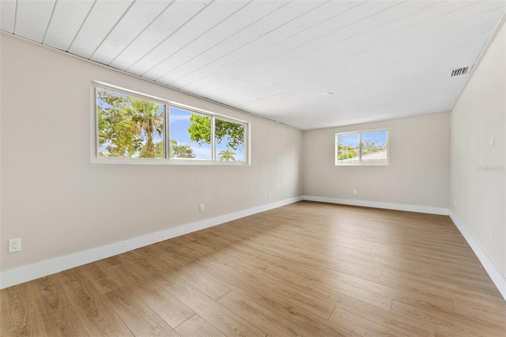 1822 Banyan Tree Drive Edgewater, FL 32132 - Photo 52 of 63 a view of an empty room with wooden floor and a window