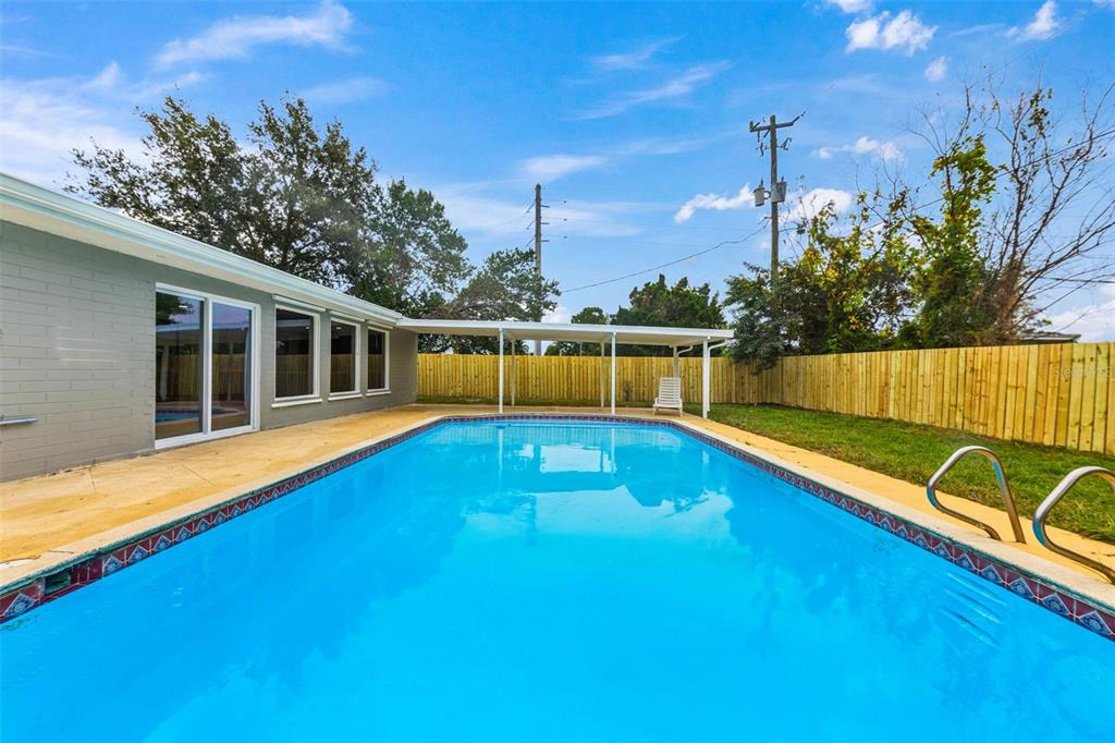 1822 Banyan Tree Drive Edgewater, FL 32132 - Photo 56 of 63 a view of a swimming pool with a lounge chairs