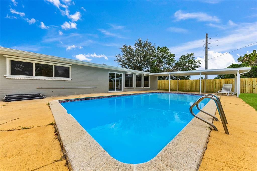 1822 Banyan Tree Drive Edgewater, FL 32132 - Photo 60 of 63 a view of a swimming pool with a patio