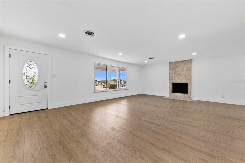 1822 Banyan Tree Drive Edgewater, FL 32132 - Photo 9 of 63 a view of empty room with wooden floor and fireplace