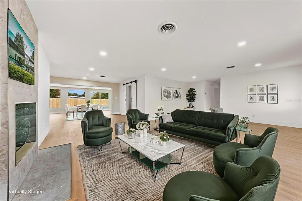 1822 Banyan Tree Drive Edgewater, FL 32132 - Photo 10 of 63 a living room with furniture ceiling fan and a rug