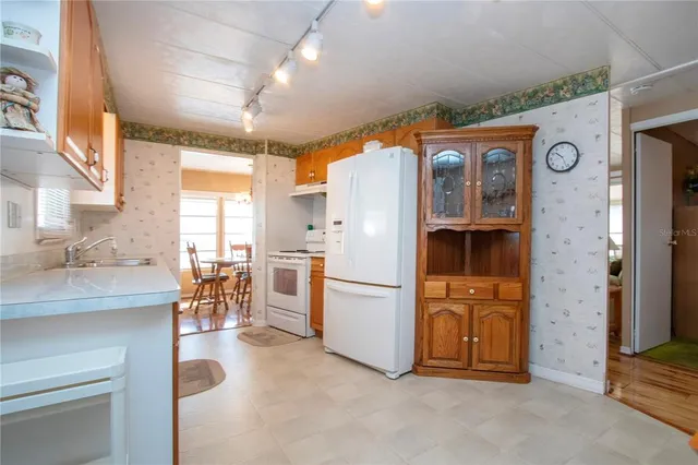 a bathroom with a granite countertop sink mirror and a toilet