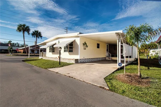 a front view of a house with a yard table and chairs