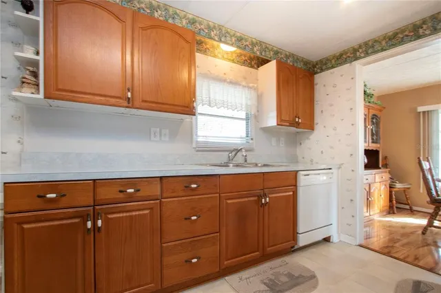 a dining room with furniture a chandelier and wooden floor