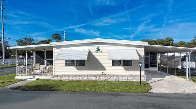 a view of a dining room with furniture a chandelier and wooden floor