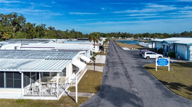 a view of a dining room with furniture a chandelier and wooden floor