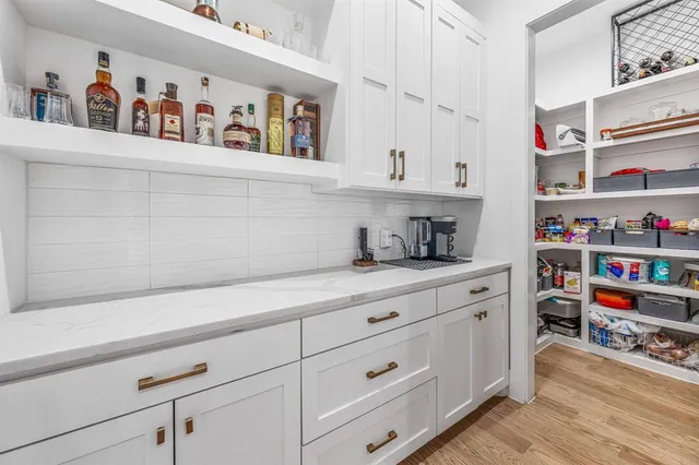 a kitchen with cabinets and window